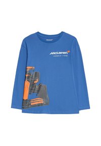 Niebieska koszulka z długim rękawem z grafiką samochodu Formuły 1 w kolorach szarym i pomarańczowym, z wyraźnie widocznym logo McLarena.