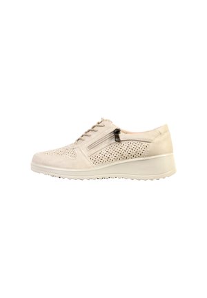 Chaussure décontractée beige pour femme avec lacets sur le devant, fermeture éclair latérale, détails perforés et semelle légèrement surélevée.