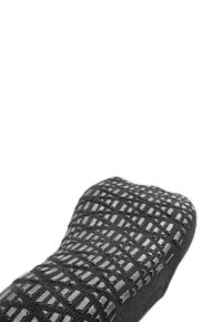 Black sock with textured pattern, features a grid design of varying rectangular shapes, made of soft fabric with a smooth finish.