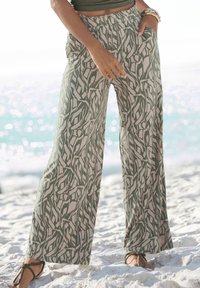 Wide-leg pants in a light olive green with a contrasting white leaf pattern; features an elastic waistband and side pockets.