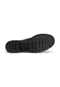 Suela de zapato de goma negra con un patrón texturizado que presenta surcos y elementos elevables para mayor tracción. Se encuentran el logotipo y las marcas de tamaño.