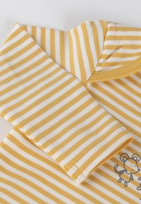 Yellow and white striped long-sleeve baby shirt with collar and small mouse character printed on the lower right side.