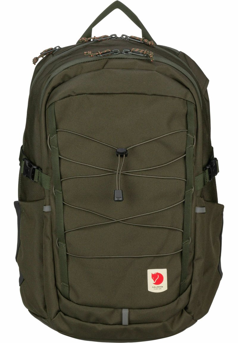 Green fabric backpack with a rectangular shape. Features a central bungee cord design, multiple pockets, and a logo patch on the front.