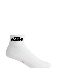 Chaussette de cheville en coton blanc avec un rebord côtelé, arborant un logo "KTM" noir et un indicateur de taille orange sur la semelle.