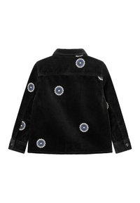 Veste en velours côtelé noire avec broderies florales bleues et blanches, à col, manches longues et poignets boutonnés.