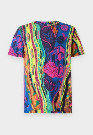 Colorful short-sleeved t-shirt featuring a vibrant pattern of abstract shapes and stylized buildings in neon shades of blue, pink, and green.