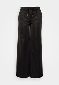 Pantalones anchos negros con una cinturilla elástica y un cordón negro, exhibidos sobre un fondo blanco liso.