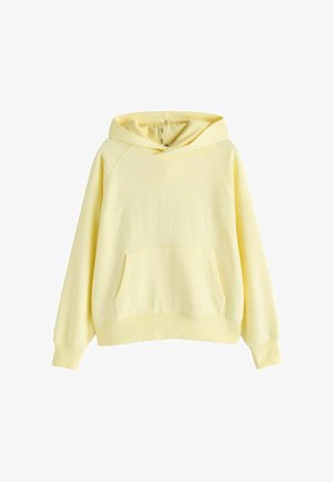 Šviesiai geltonas džemperis su gaubtu, kanguros kišene, ilgomis rankovėmis ir subtiliais reljefiniais rašmenimis ant krūtinės.