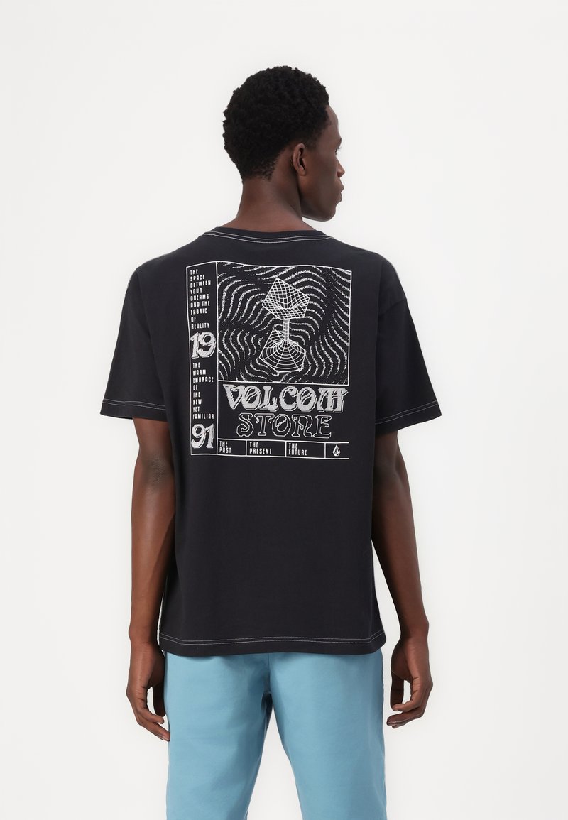 Black cotton t-shirt featuring a graphic design on the back with white text and illustrations, short sleeves, and contrasting stitching detail.