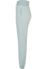 Ljusgröna joggers i bomullsblandning med ribbad midja och muddar, med sidofickor och tapered bendesign. Mjuk textur.