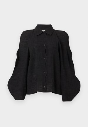 Μαύρο υφασμάτινο μπλουζάκι με κουμπιά, με δομημένους, φουσκωτούς όγκους στους ώμους και κλασικό μυτερό γιακά.