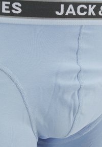 Sky blue men's boxer briefs with a black waistband featuring white text. Soft fabric with smooth texture and reinforced stitching.