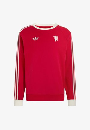 Crvena Adidas majica dugih rukava s bijelim prugama na rukavima, bijelim ovratnikom i manšetama, s Adidas logotipom i bijelim grafičkim motivom trozubca na prsištu.