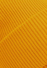 Bright yellow knitted fabric with textured ribbing, featuring diagonal lines and an even pattern, creating a soft, cozy appearance.