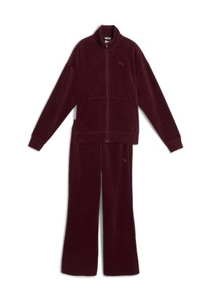 Maroon corduroy tracksuit featuring a zip-up jacket with two front pockets and matching elastic-waist pants. Textured fabric, relaxed fit.