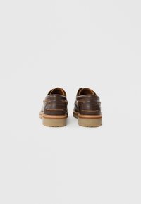 Brown leather loafers with a smooth finish, contrasting stitching, and rubber soles; features side accents and a rounded toe design.