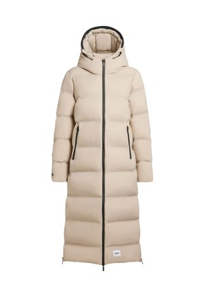 Langer beiger Steppmantel mit Kapuze, schwarzem Reißverschluss und Akzenten, gesteppter Optik und zwei Seitentaschen. Verstellmöglichkeiten am Saum.