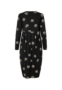 Černé šaty s dlouhým rukávem a krémovým puntíkovaným vzorem, mají skládací sukni a měkkou texturovanou látku. Kolo výstřih, volný střih.