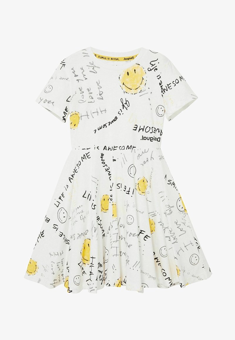 Robe blanche à manches courtes avec des visages jaunes souriants et des phrases manuscrites noires comme "La vie est géniale" et "J'aime ma vie."