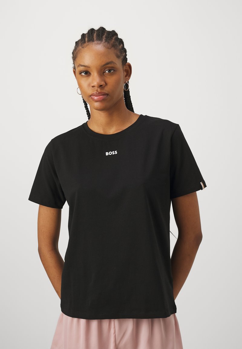Black cotton t-shirt with short sleeves featuring a white "BOSS" logo on the chest and a small accent on the sleeve. Smooth texture.