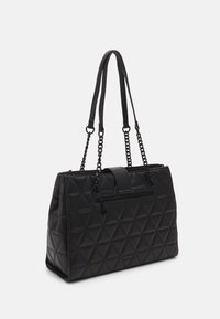 Czarna pikowana torebka z trójkątnym wzorem, wyposażona w górny zamek błyskawiczny, płaski uchwyt oraz pasek z łańcuszkiem dla dodatkowego efektu.