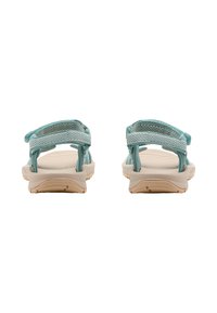 Teal fabric sandals with adjustable straps, a lightweight cream sole, and textured footbed, designed for comfort and support.