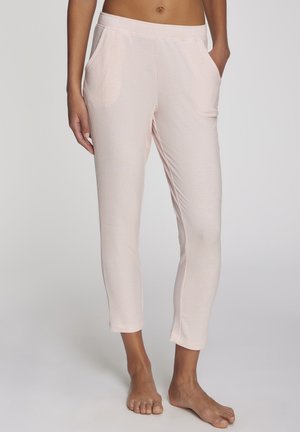 Light pink ribbed lounge pants with an elastic waistband, side pockets, and cropped length, featuring a smooth texture and fitted design.