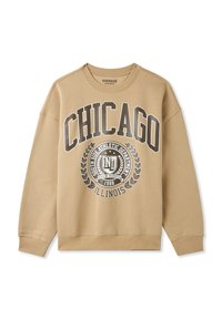 Felpa oversize beige con la scritta "CHICAGO" in grigio bold, accompagnata da un emblema grafico e accenti di alloro centrati sotto.