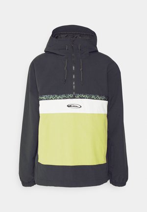 Svart och limegrön anorakjacka med halvdragkedja, som har en vit och mönstrad mittsektion och en justerbar huva.