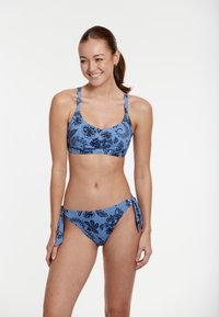 Mėlyna bikini komplektas su gėlių raštu, turintis braleto tipo viršūnę su reguliuojamomis petnešėlėmis ir juosmens dalį su raišteliais ir šoninėmis juostelėmis.