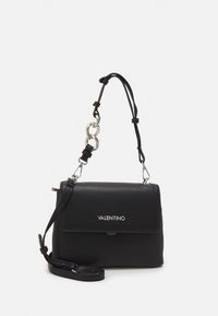 Black leather handbag with a folded flap, silver hardware, detachable shoulder strap, and logo detailing on the front. Compact rectangular shape.