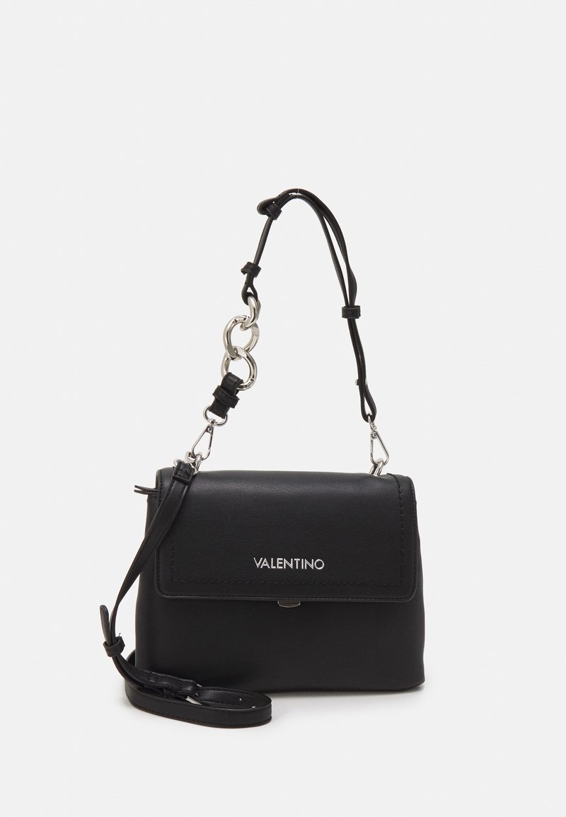 Black leather handbag with a folded flap, silver hardware, detachable shoulder strap, and logo detailing on the front. Compact rectangular shape.