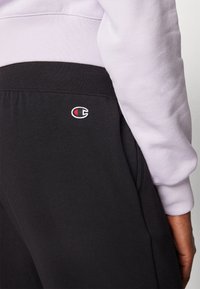 Champion ICONS CUFF PANTS LARGE LOGO - Tréningruha alsók - black