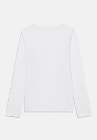 Long-sleeve white cotton t-shirt with a crew neck. Features a plain design and a relaxed fit. No visible patterns or accents.