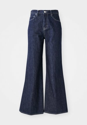 Mørke denim flared jeans med høj talje, der har knap- og lynlåslukning. Hvide syninger og brede ben skaber en struktureret silhuet.
