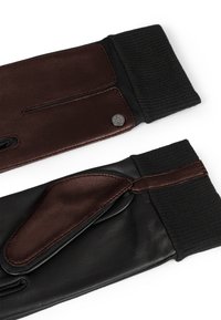Guanti in pelle con toni di marrone scuro e nero, dotati di polsino in tessuto a coste, design minimalista e una piccola accentazione con logo.