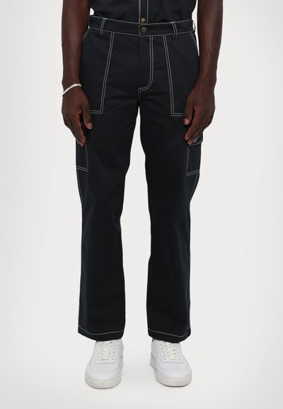 Black cargo pants with white stitching, featuring front pockets and side cargo pockets. Designed with a relaxed fit and a sturdy fabric.