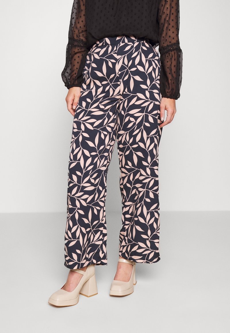 Wide-leg pants in navy blue fabric, featuring a pink leaf pattern. Smooth texture with a high waist and relaxed fit. Paired with beige heels.