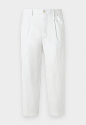 White cotton trousers with a straight cut, featuring a button closure, pleated front, and rolled hems. Smooth texture with no visible patterns.