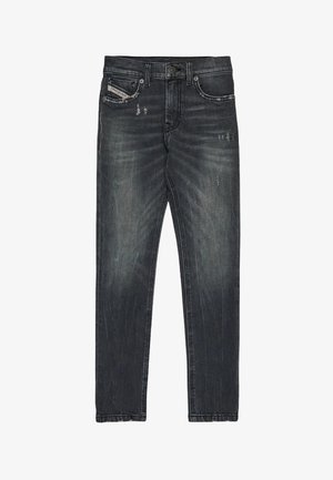 Tmavohnedé džínsy so slim fit strihom, s jemným poškodeniam, klasickým dizajnom s piatimi vreckami a zapínaním na gombíky.