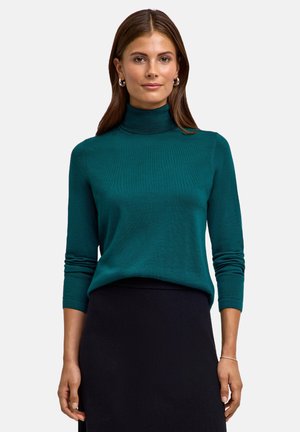 Teal turtleneck sweater with long sleeves, soft texture, and a fitted design. Paired with a black skirt. Simple and clean lines.