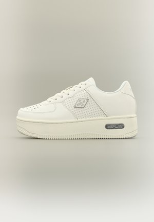 White low-top sneaker with perforated side panel, lace-up design, thick sole, and "Replay" logo on side and heel.