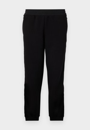 Svarta sweatpants tillverkade av ett mjukt material, med ett elastiskt midjeband, snäva ärmslut och sidofickor för extra bekvämlighet.