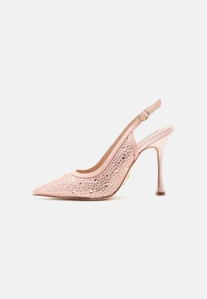 Chaussure slingback à talon haut rose avec bout pointu, décorée de petits clous ronds, et une boucle dorée sur la bride.