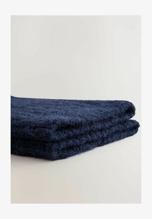 Navy blue knitted blanket made of soft, textured fabric, folded neatly to showcase its thickness and fiber detail.