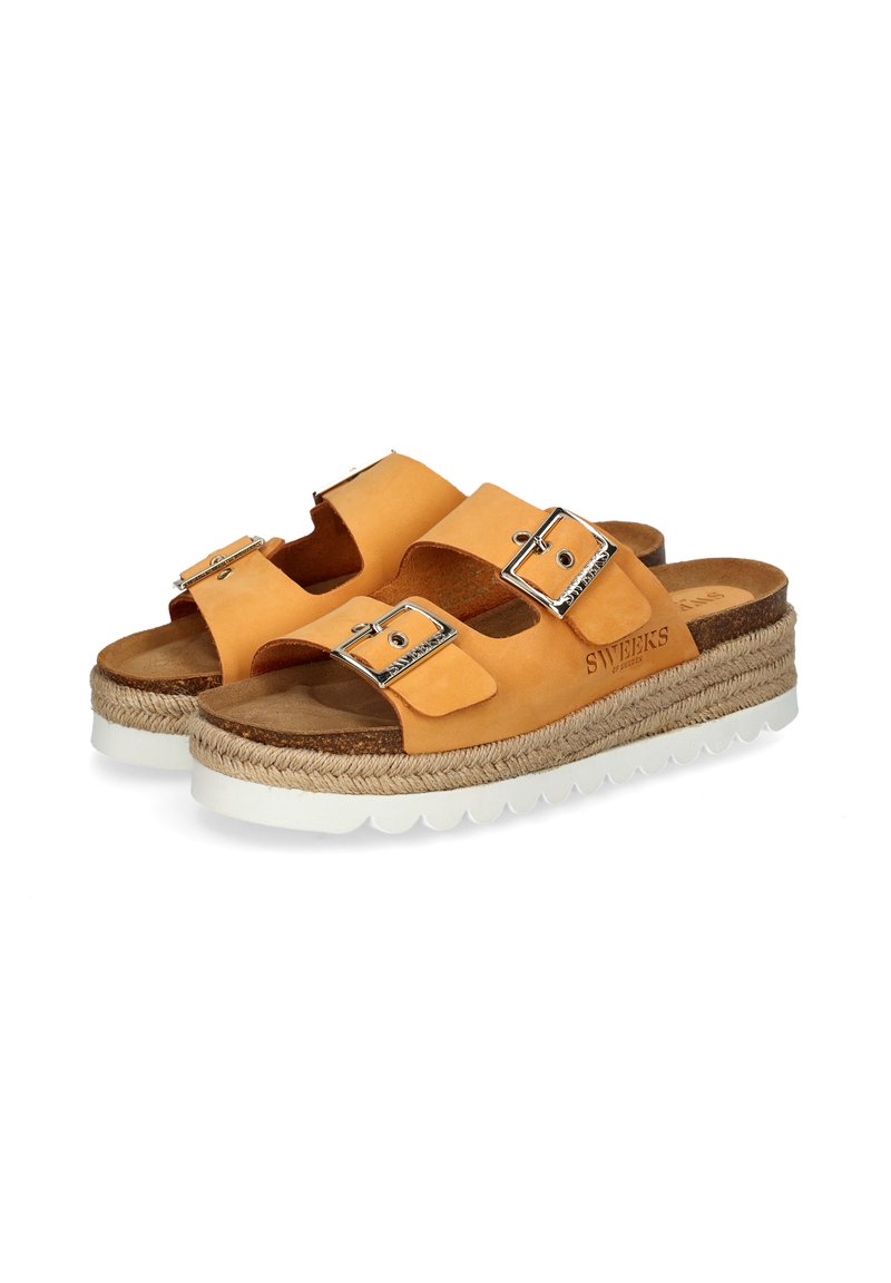 Tan leather sandals with two adjustable buckles, jute-wrapped midsole, and a white, textured rubber outsole.