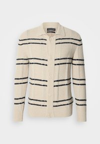 Bēša kardigāns no faktūras materiāla ar tumši ziliem horizontāliem svītrām, apkakli un aizdari ar pogām.