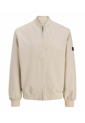 Beež bomberjakk esiluku, soonikkoes krae, mansetid ja ääred ning väike must plaastr vasakul varrukal.