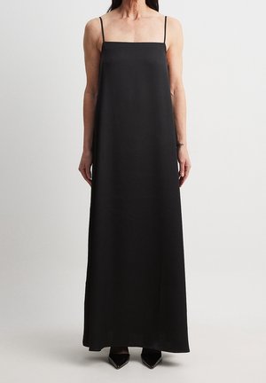 Black sleeveless maxi dress with a square neckline, made of smooth fabric, featuring a loose fit and side slits for ease of movement.