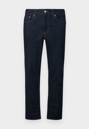 Σκούρα μπλε τζιν με ίσια γραμμή, πέντε τσέπες, πορτοκαλί ραφές και ασημένιο κούμπωμα στη μέση.